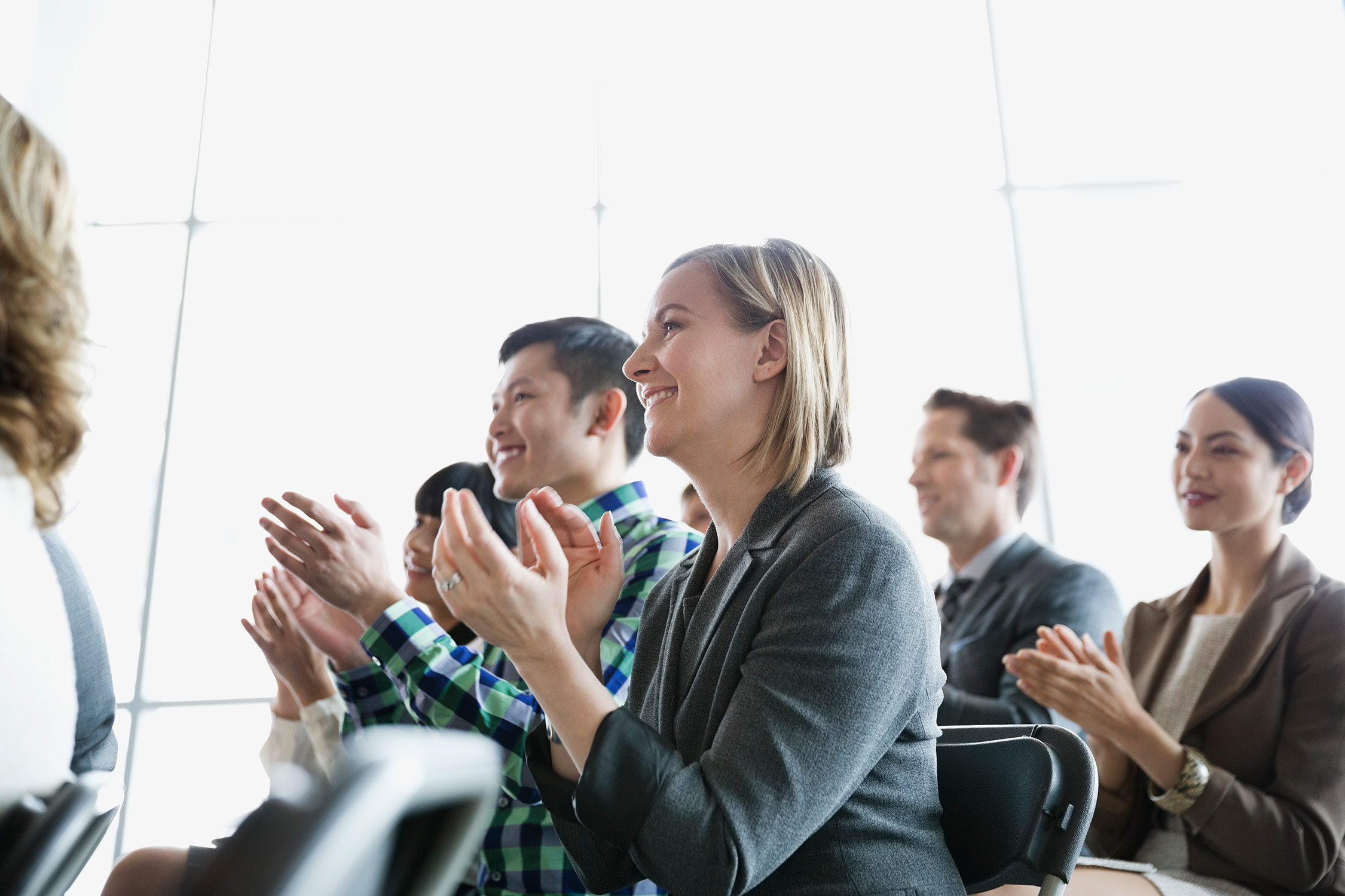 A group of students clapping at an event